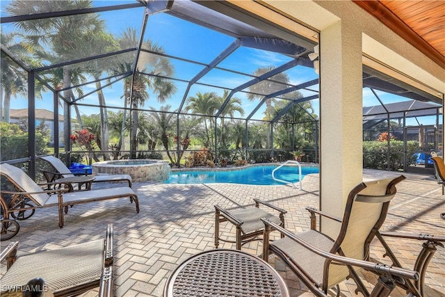 view of swimming pool featuring glass enclosure, an in ground hot tub, and a patio