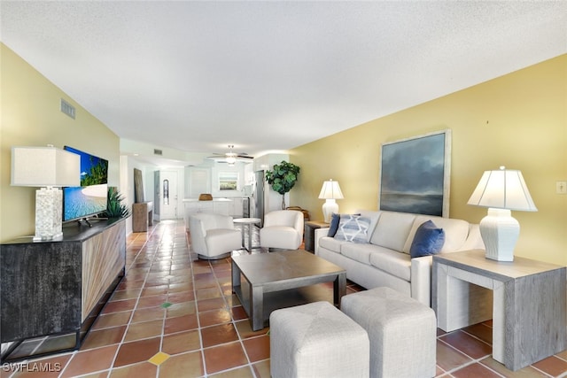 tiled living room with ceiling fan