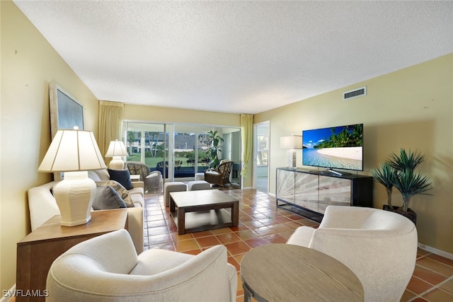 living room with a textured ceiling and tile patterned floors