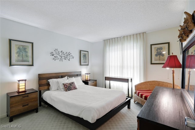 carpeted bedroom featuring a textured ceiling