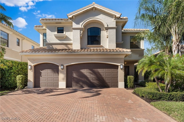 mediterranean / spanish-style home featuring a garage