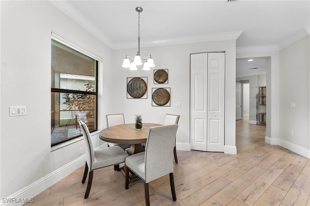 dining room with crown molding, a chandelier, and light wood-type flooring