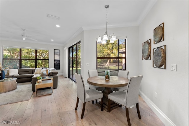 dining space featuring ceiling fan with notable chandelier, light hardwood / wood-style floors, and a wealth of natural light