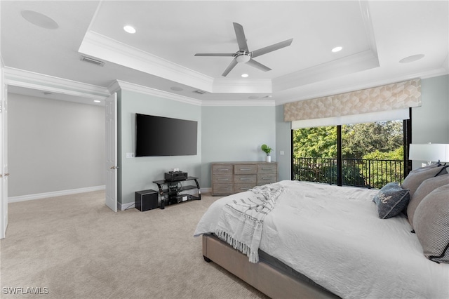 carpeted bedroom featuring access to exterior, ceiling fan, a raised ceiling, and ornamental molding