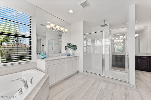 bathroom featuring vanity and separate shower and tub