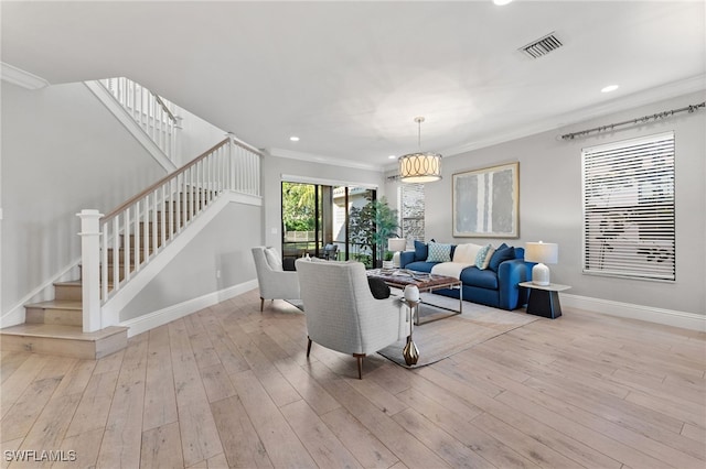 living room featuring light hardwood / wood-style floors and crown molding