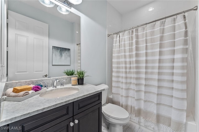 full bathroom featuring shower / tub combo, vanity, and toilet