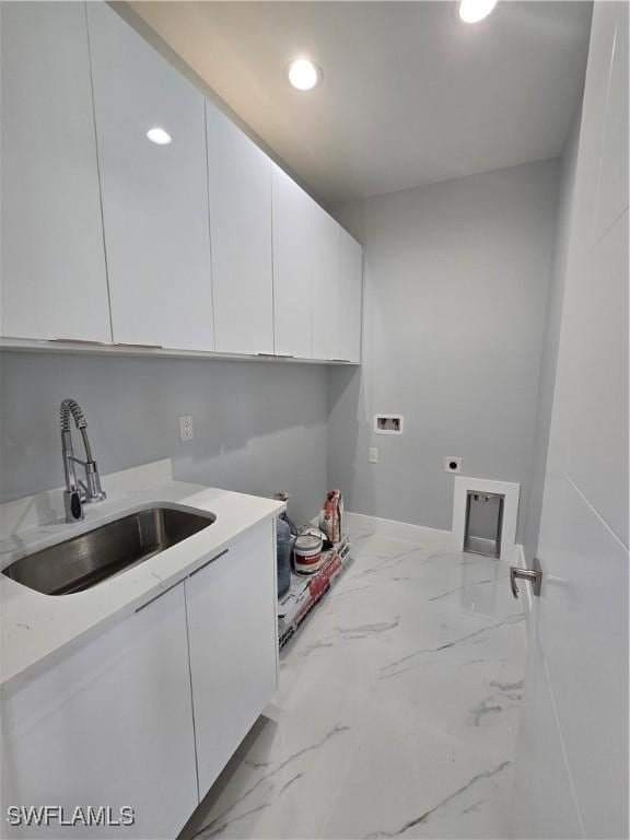 laundry area with cabinets, washer hookup, hookup for an electric dryer, and sink