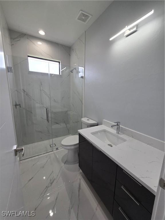 bathroom featuring an enclosed shower, vanity, and toilet