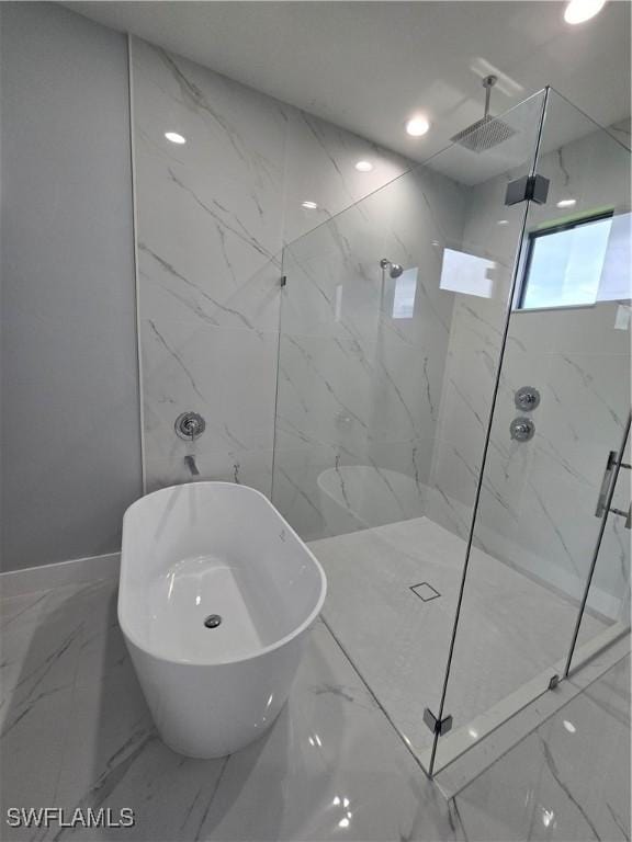 bathroom featuring separate shower and tub