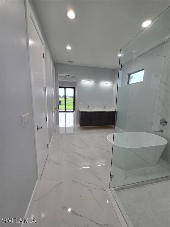 bathroom with separate shower and tub and vanity