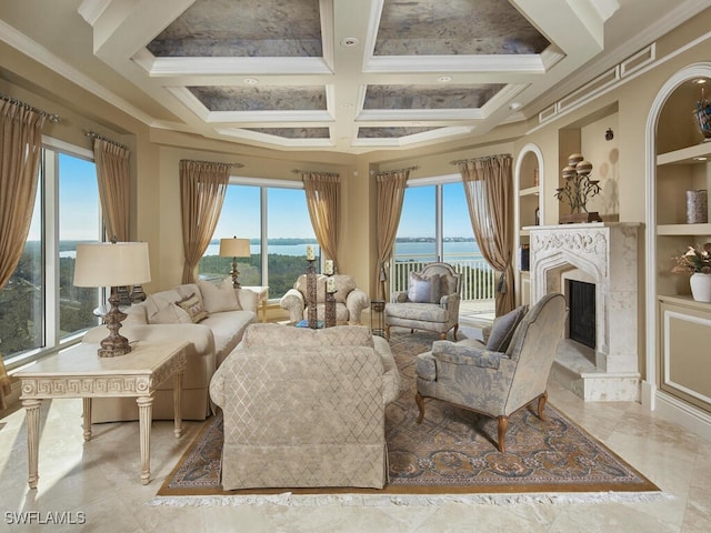 living area featuring a premium fireplace, ornamental molding, built in shelves, and a water view