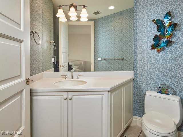 bathroom featuring toilet, vanity, and tile patterned floors