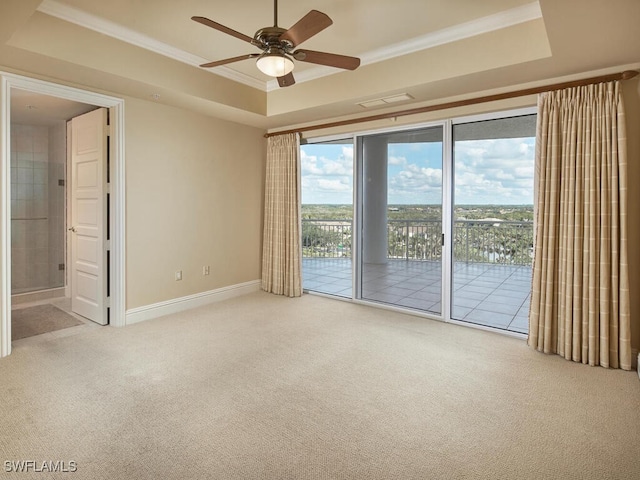 empty room with ceiling fan, crown molding, carpet, and a tray ceiling