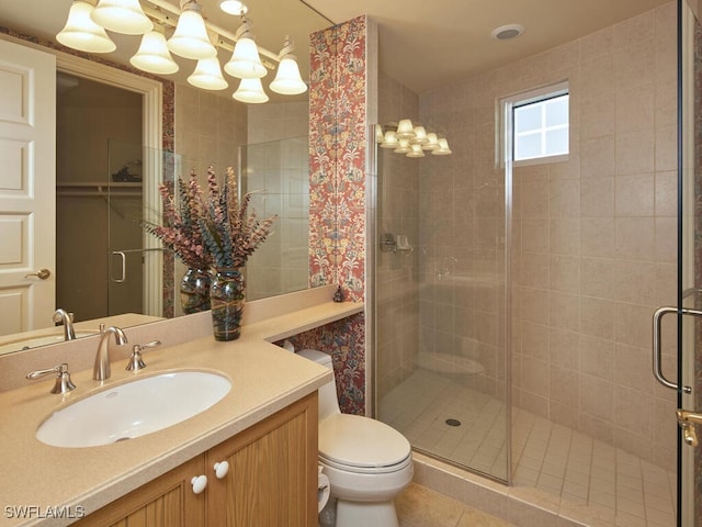 bathroom with toilet, tile patterned flooring, walk in shower, and vanity