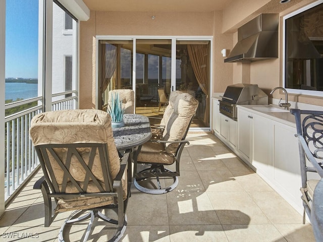 sunroom with sink and a water view