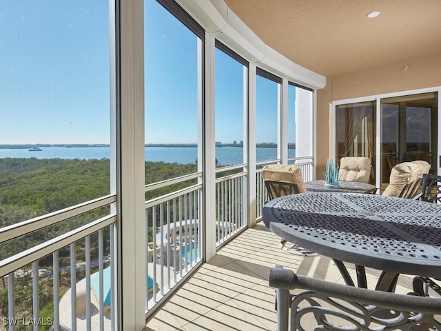 sunroom / solarium with a water view