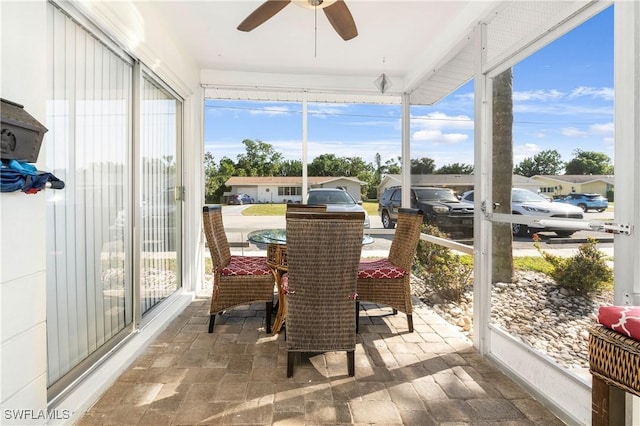 sunroom featuring a wealth of natural light and ceiling fan