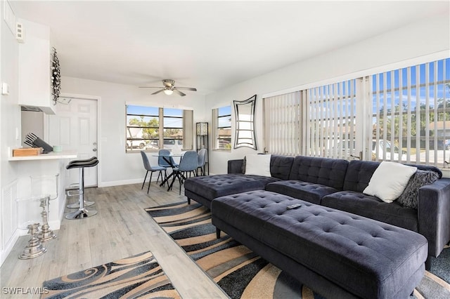 living room featuring ceiling fan and light hardwood / wood-style floors