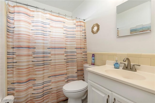 bathroom featuring vanity, tasteful backsplash, toilet, and walk in shower