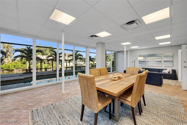 dining area featuring a drop ceiling