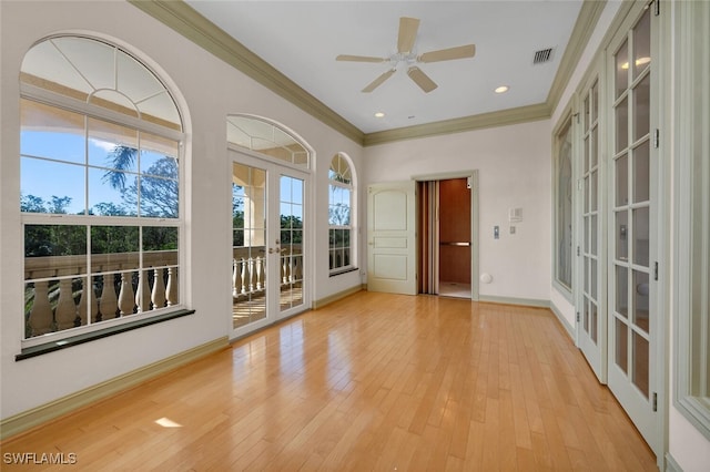 interior space featuring crown molding, light hardwood / wood-style flooring, ceiling fan, and french doors