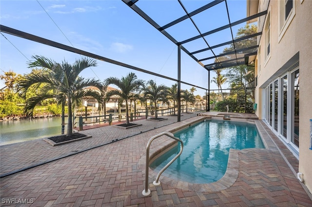 view of pool with a patio and glass enclosure