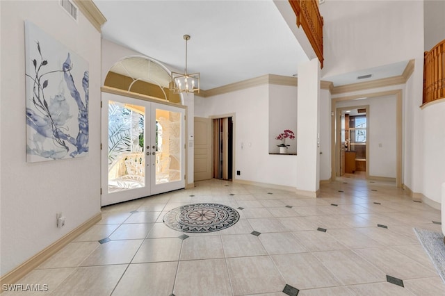 entryway featuring crown molding, light tile patterned floors, a notable chandelier, and french doors