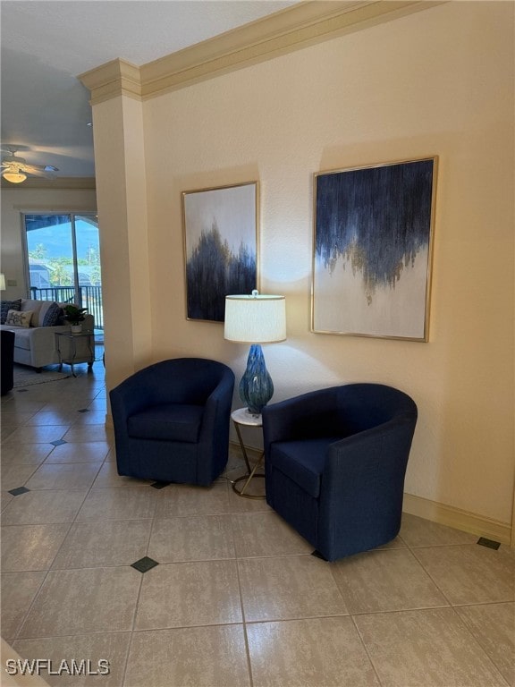 sitting room featuring ceiling fan, tile patterned floors, and ornamental molding