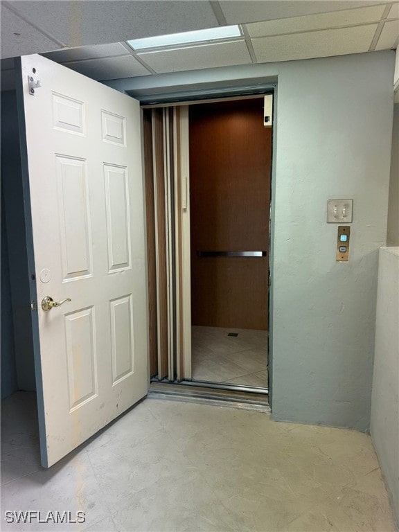 hallway featuring a paneled ceiling