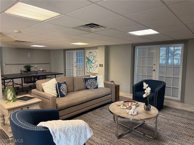 living room featuring a paneled ceiling and french doors