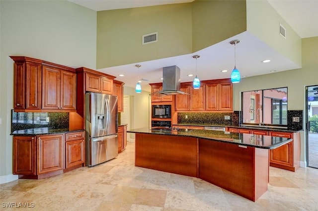 kitchen with a kitchen island, island range hood, dark stone counters, hanging light fixtures, and black appliances