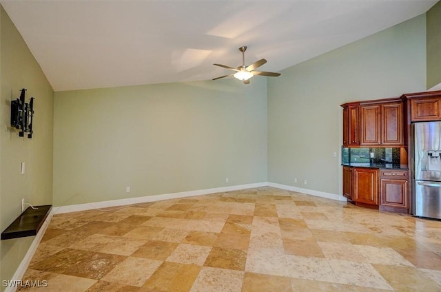 kitchen featuring stainless steel refrigerator with ice dispenser, ceiling fan, decorative backsplash, and lofted ceiling