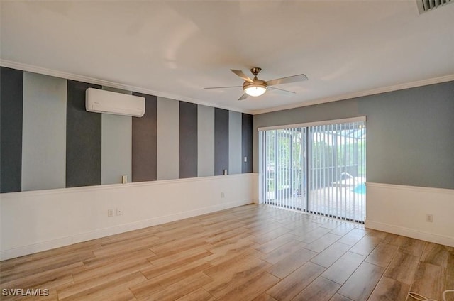 empty room featuring a wall unit AC, ceiling fan, ornamental molding, and light hardwood / wood-style floors