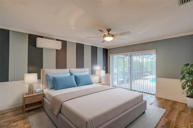 bedroom with ornamental molding, access to exterior, ceiling fan, light hardwood / wood-style floors, and a wall unit AC