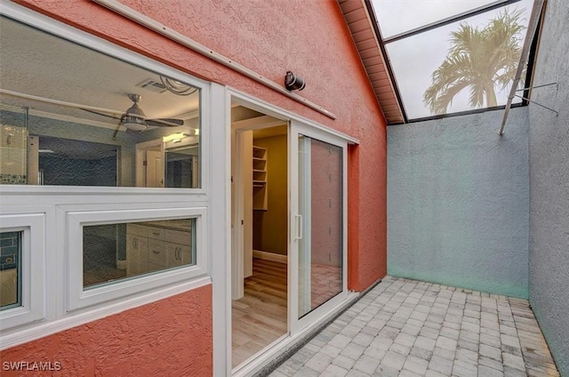 unfurnished sunroom featuring lofted ceiling and ceiling fan