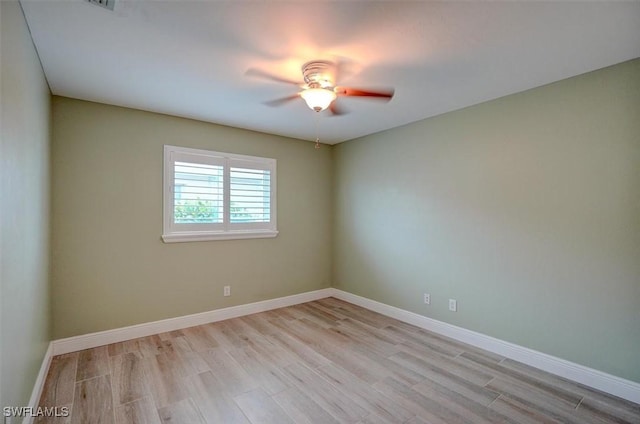 empty room featuring ceiling fan and light hardwood / wood-style flooring