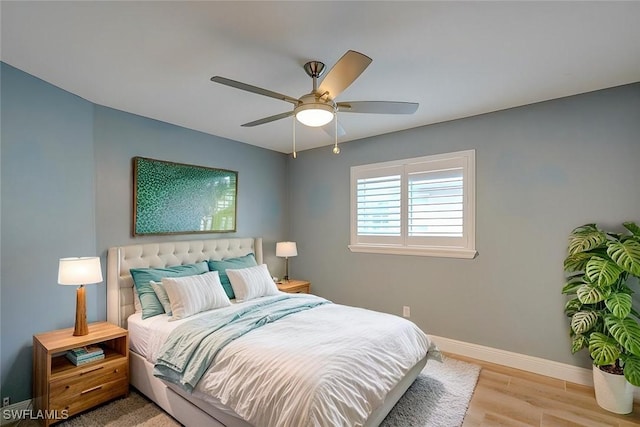 bedroom with ceiling fan and light hardwood / wood-style floors