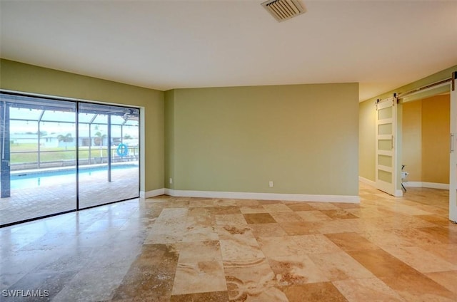 empty room featuring a barn door