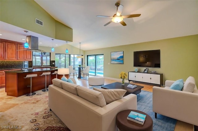 living room with high vaulted ceiling and ceiling fan