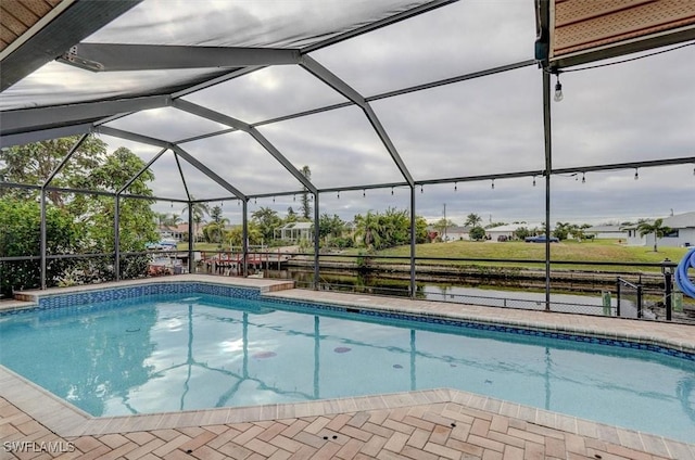 view of pool featuring glass enclosure