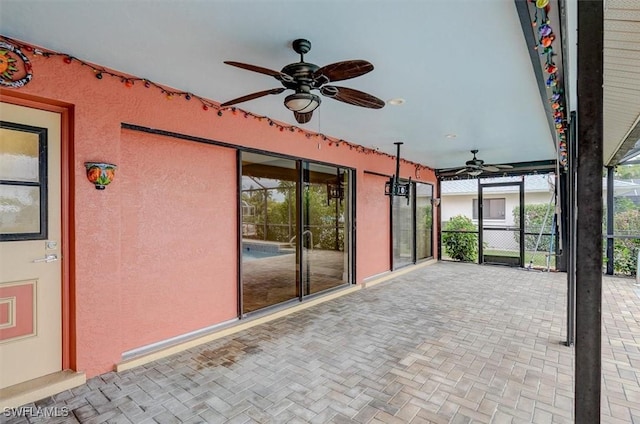 unfurnished sunroom with ceiling fan