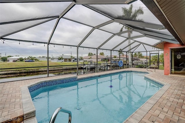 view of swimming pool with a patio area and glass enclosure