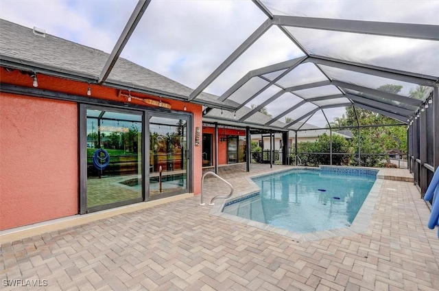 view of pool with a lanai and a patio