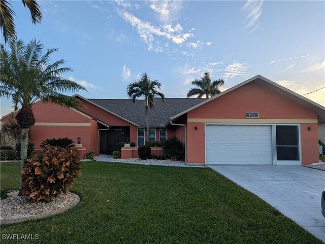 single story home with a lawn and a garage