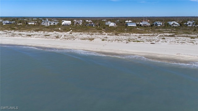 birds eye view of property featuring a view of the beach and a water view