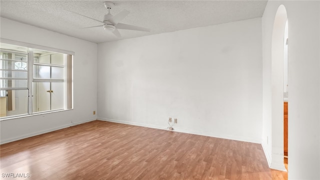 spare room featuring ceiling fan, a textured ceiling, and light hardwood / wood-style flooring