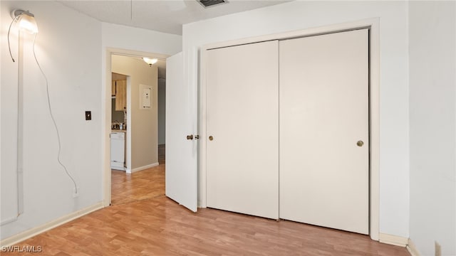 unfurnished bedroom featuring a closet and light wood-type flooring