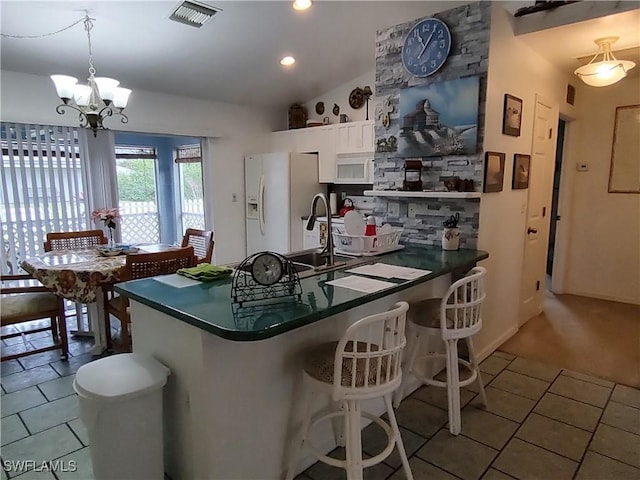 kitchen with white cabinetry, white appliances, light tile patterned floors, and decorative light fixtures