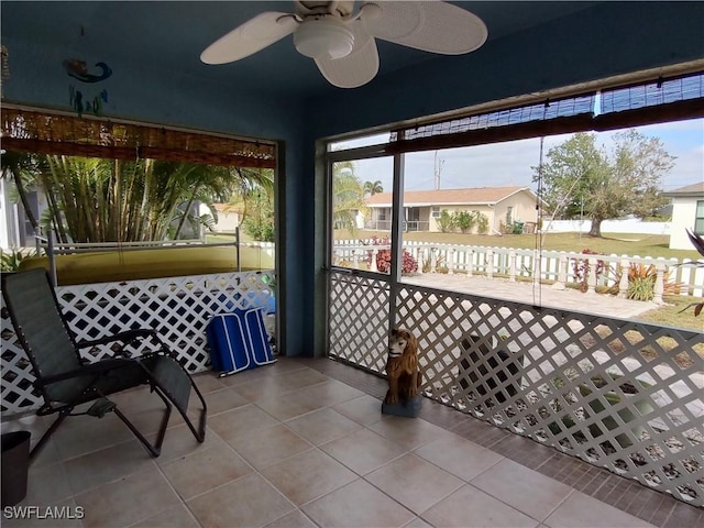 sunroom / solarium featuring ceiling fan and a healthy amount of sunlight